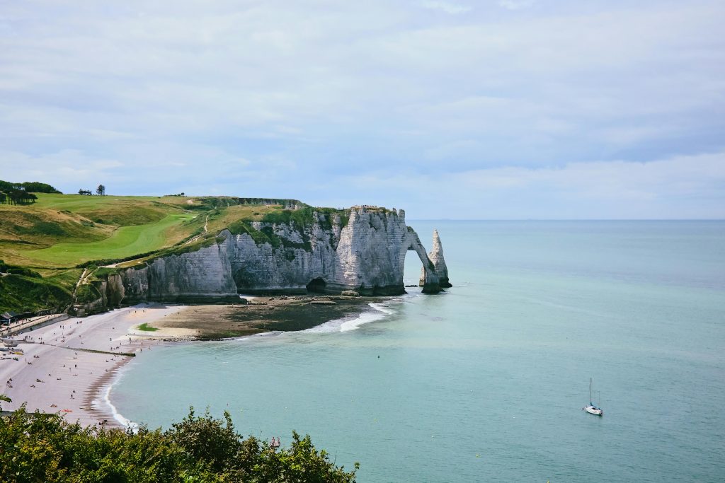 Explore the stunning white cliffs and natural arches of Étretat, a must-see landmark in Normandy.