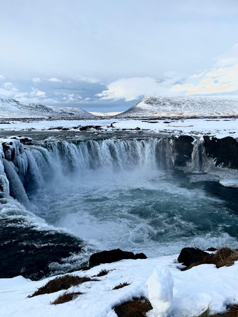 Capture of the stunning Godafoss waterfall surrounded by snow in Þingeyjarsveit, Iceland.